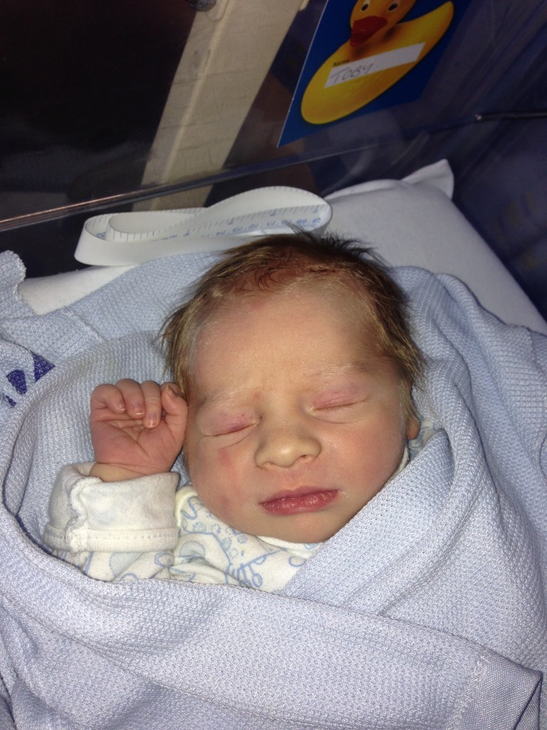 newborn toby raising the rings