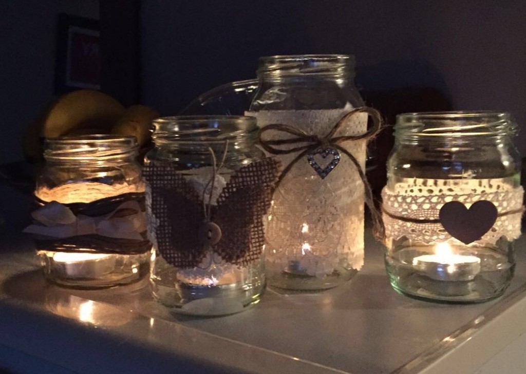 homemade home made wedding jars decorated lace vintage hessian crochet jackets twine hearts candle holders flower arrangements bows satin neutral beautiful decoration centrepieces tables