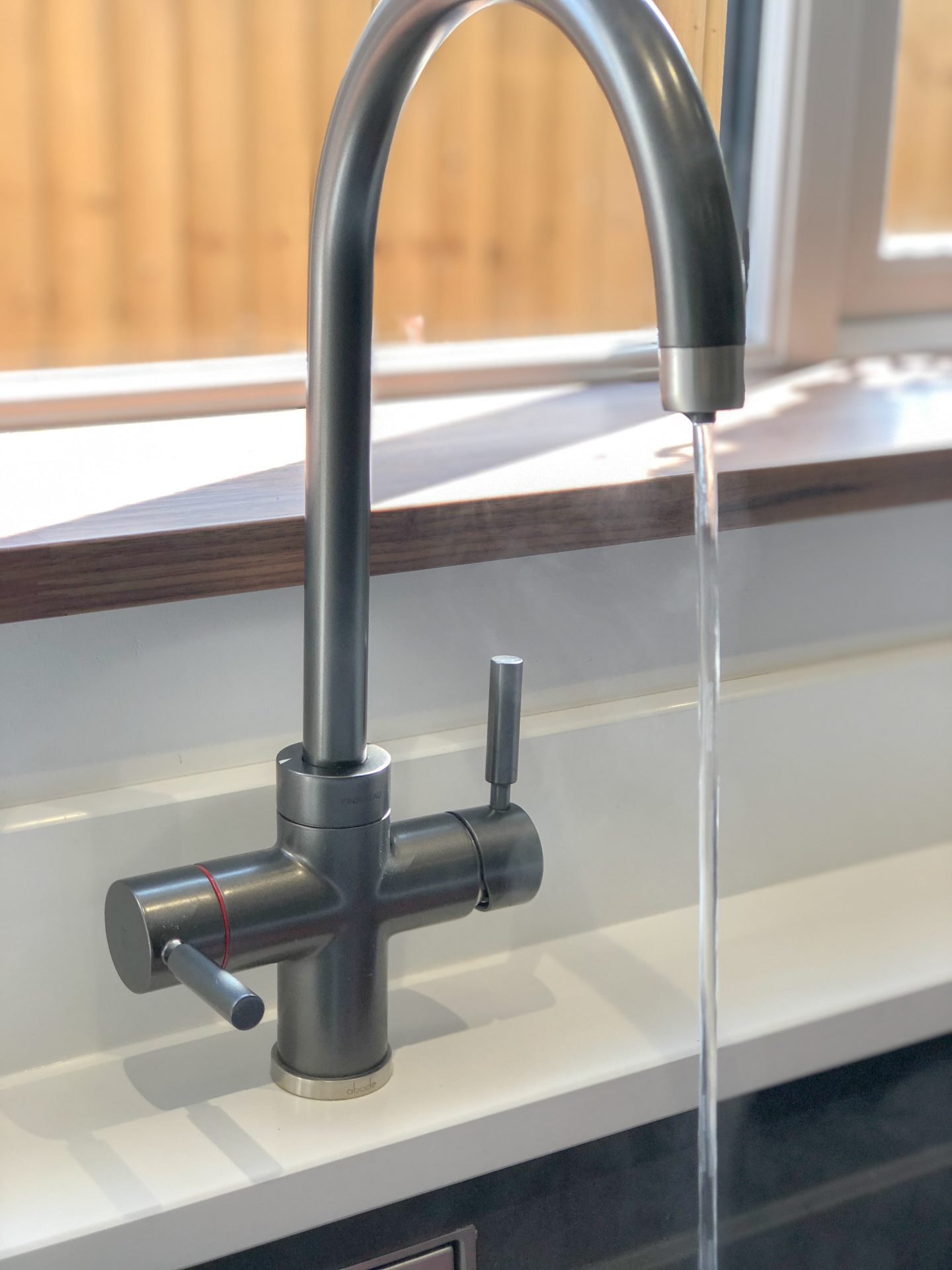 making our house a home why we chose a hot tap instead of a kettle close up of abode pronteau 3-in-1 tap in brushed nickel fitted on white quartz worktop showing hot water stream