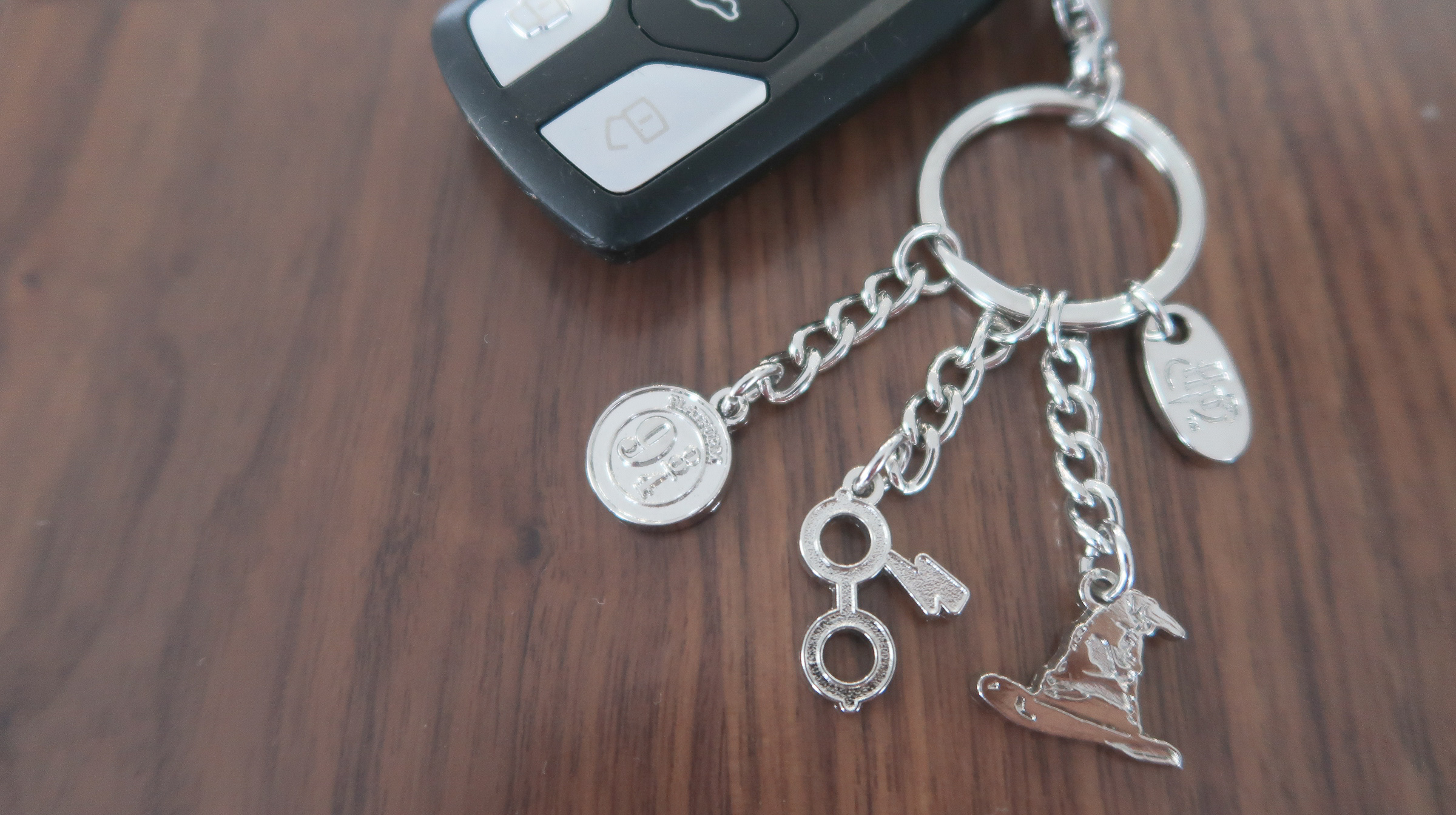 Set of keys on table with Harry Potter charm key ring