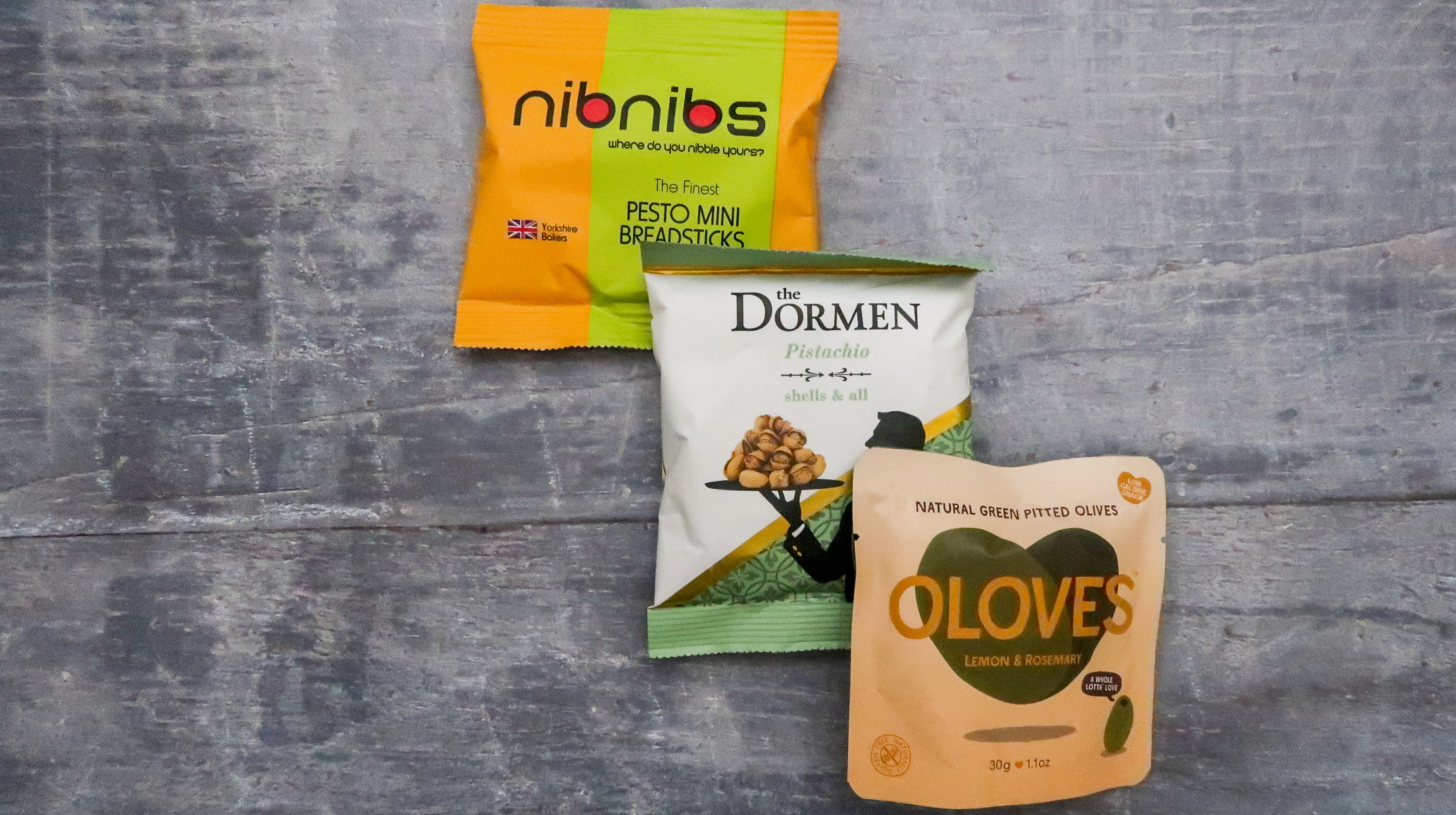 packets of pesto mini breadsticks dormen pistachios and oloves olives