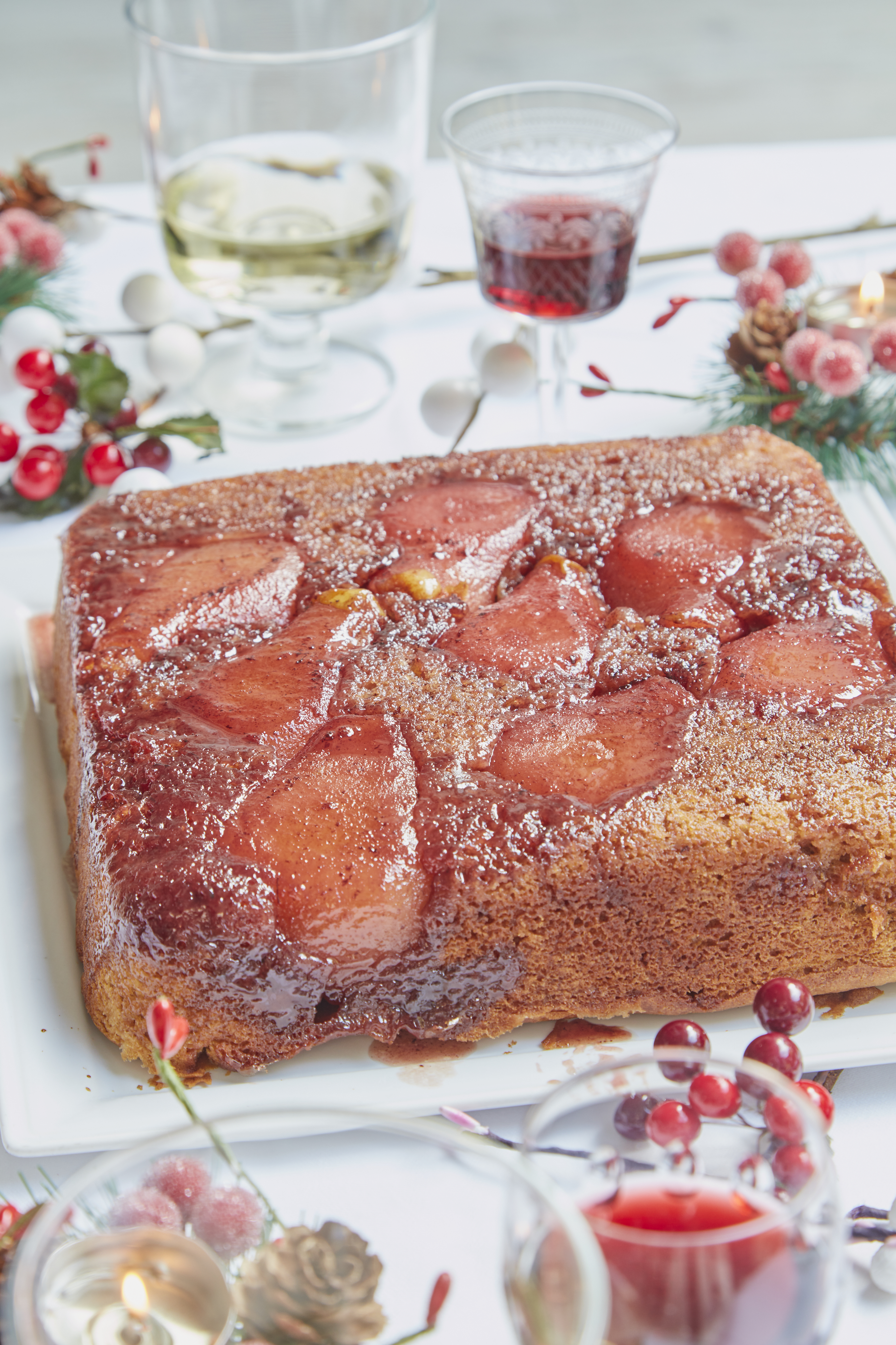 pear and port cake displayed on table with red sherry and white wine in glasses