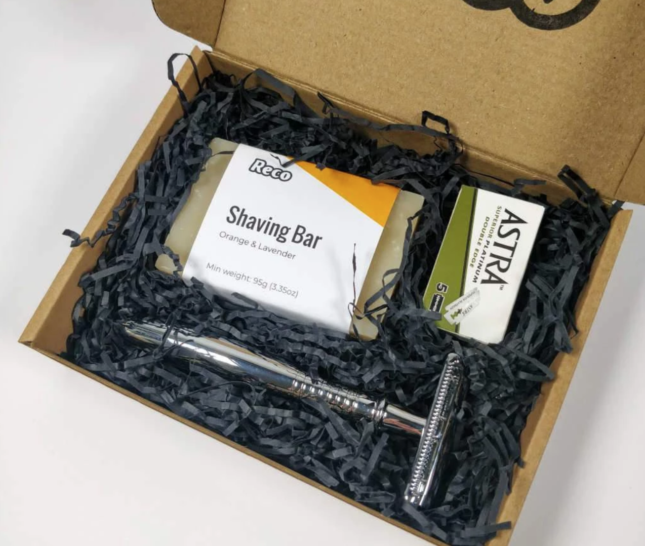 reco eco-friendly shaving starter set with safety razor orange and lavender soap and replacement blades set on black strip package stuffing